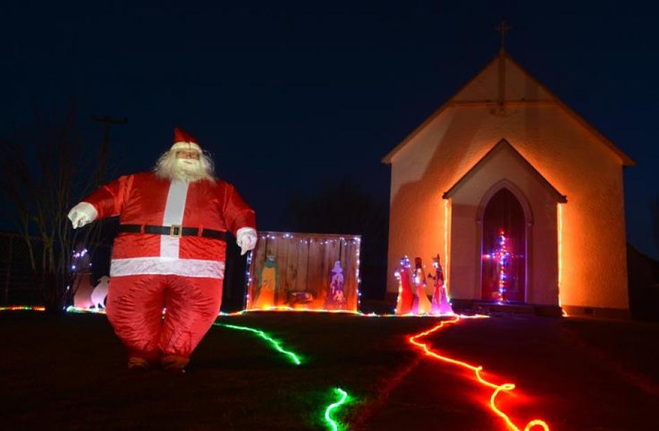 Middlemarch resident Irene Ramsay, dressed as Santa outside St Paul's Catholic Church.