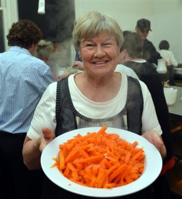 Mary Suddaby, of Middlemarch, holds food prepared for the dinner.