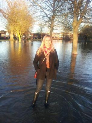 Laura Todd stands in floodwaters at Marlow, near her former home in High Wycombe, north of London...