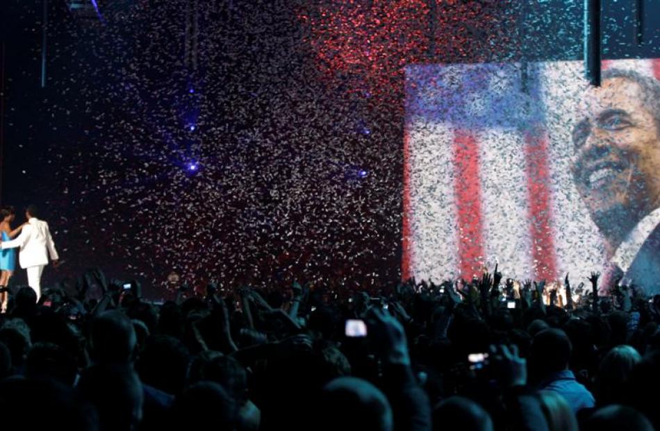 British singer Estelle and US musician Kanye West, left, on stage whilst the screen shows an...