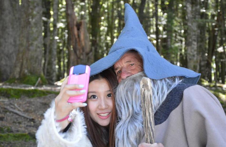 Dart River Jet guide Rod Spackman, as Gandalf, gets in a ''selfie'' with a tourist during a tour...