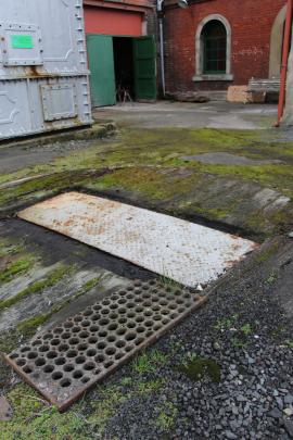 An unsealed patch of ground surrounding an in-ground sump filled with sludge on the Dunedin...