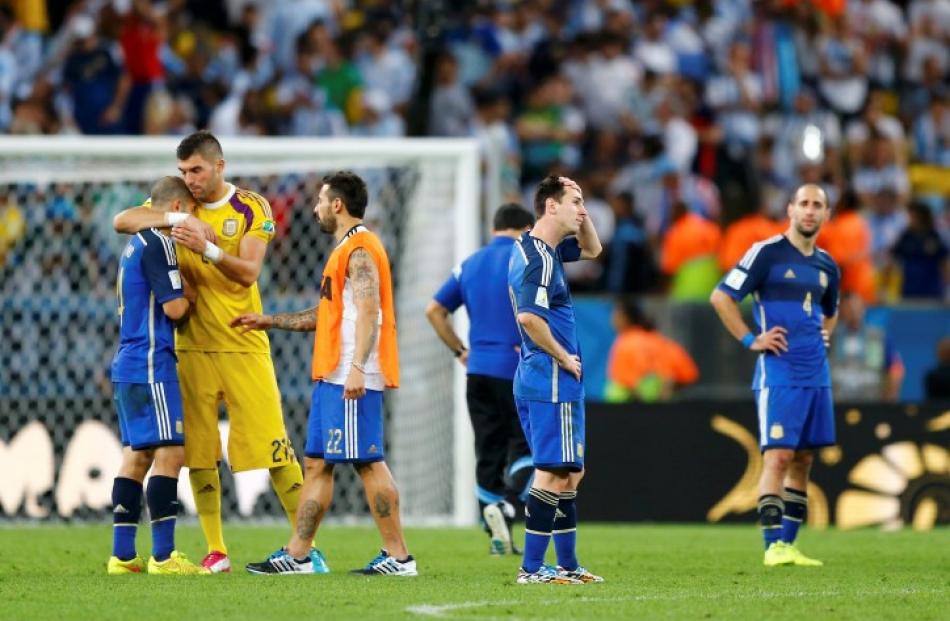 Argentina players show their disappointment at the end of the match. REUTERS/Darren Staples