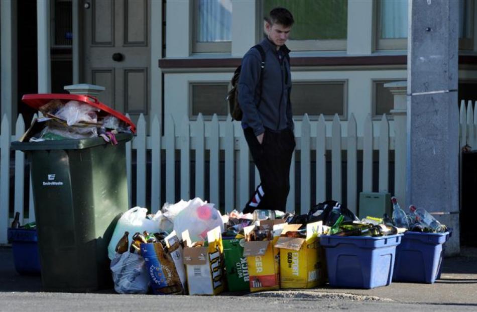 A person walks past  rubbish cleared up after weekend parties.
