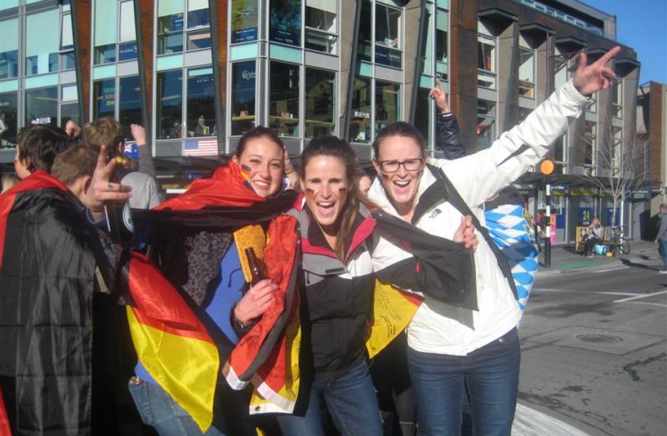 German fans (from left) Jennifer Weiss, Marie Simon and Tamara Simon, were part of a group who...