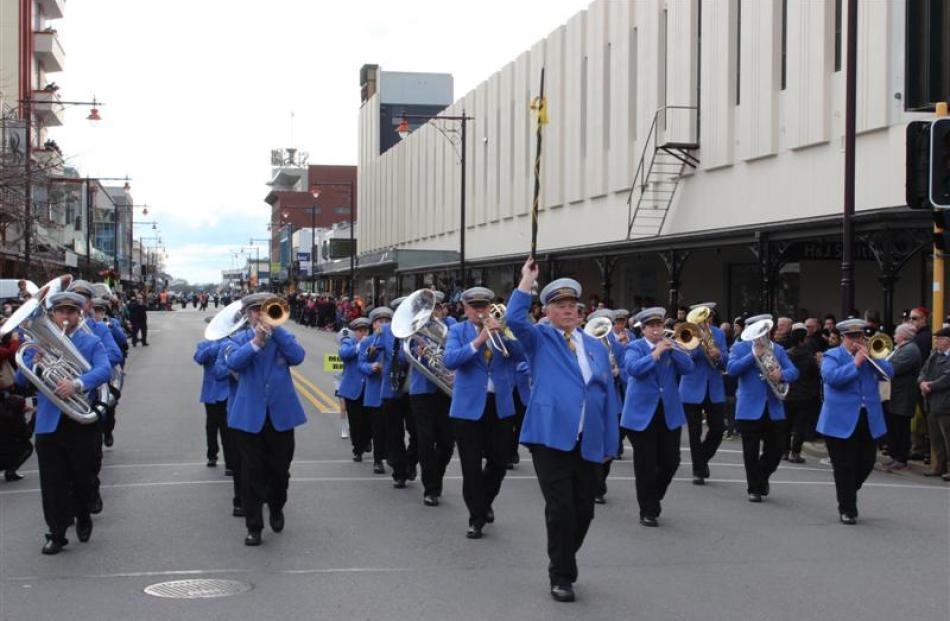 Drum major Karl Horsnell leads Mosgiel Brass during the street march.