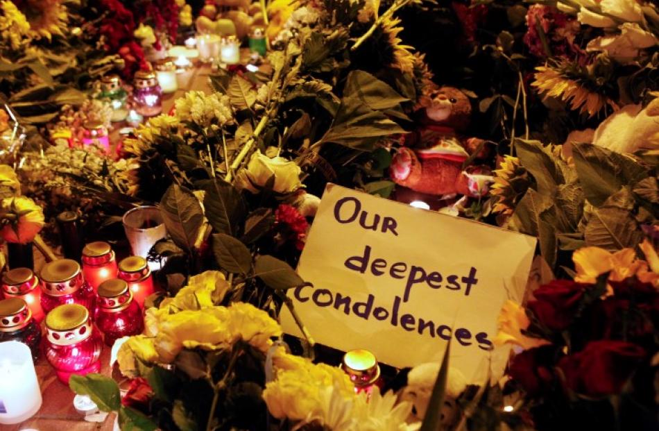 A message of condolence is left among candles and flowers near the Dutch embassy in Kiev. REUTERS...