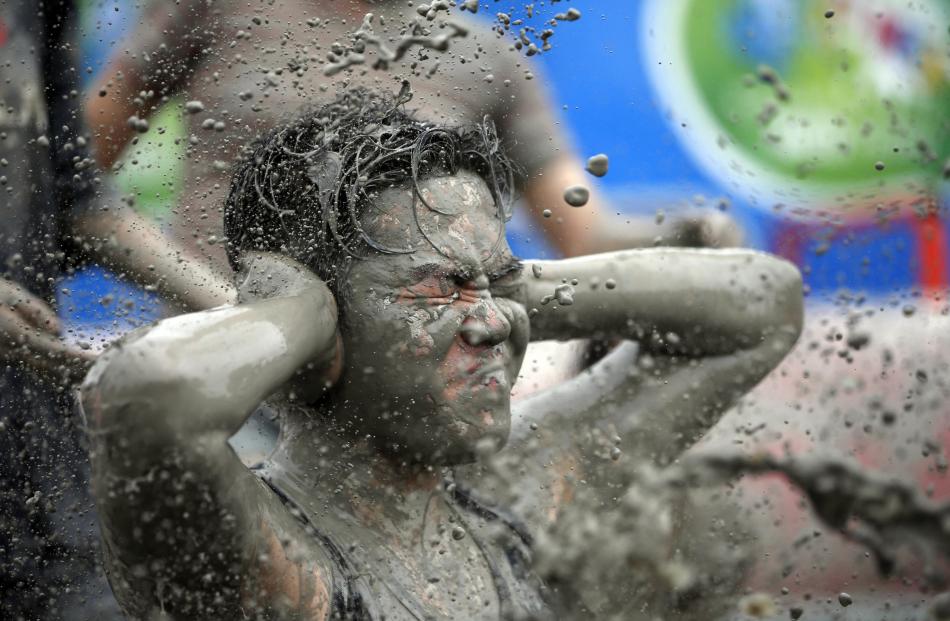 Tourists attend the Boryeong Mud Festival at Daecheon beach in Boryeong.