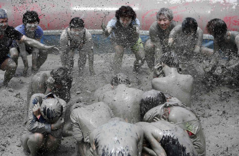 Tourists attend the Boryeong Mud Festival at Daecheon beach in Boryeong.