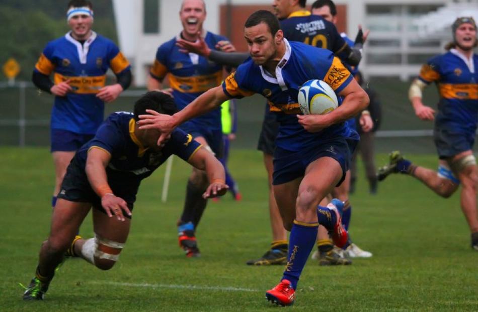 Winger Dwayne Burrows makes a strong run through a gap to score for Taieri against Dunedin.