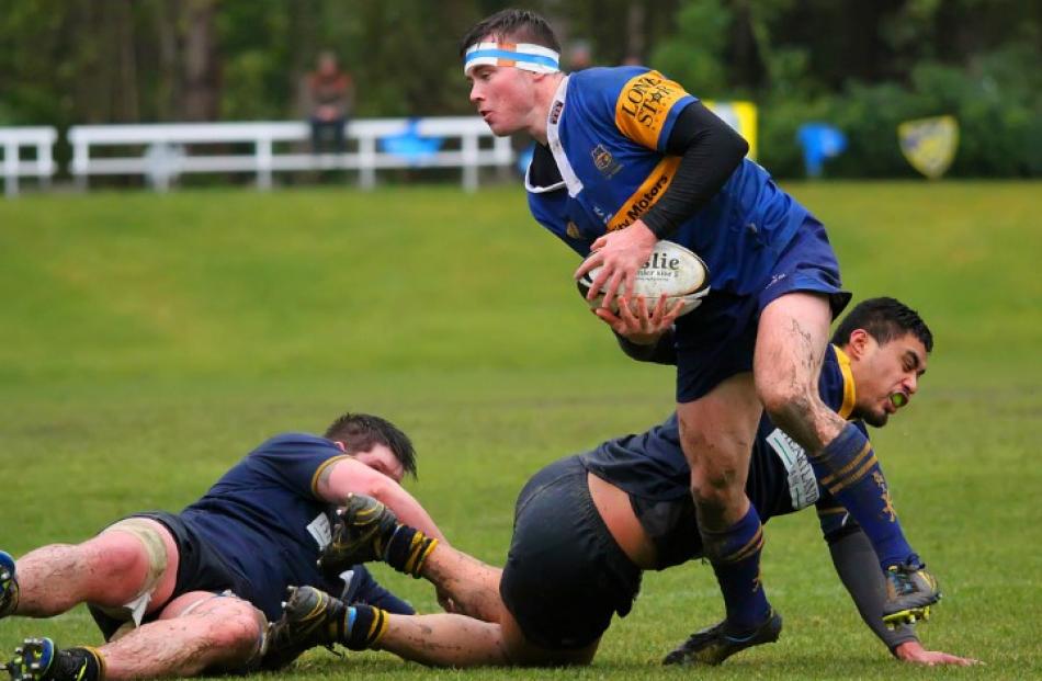 Taieri first five Josh Casey stands in the tackle of Dunedin's Kaituu Kaufana.