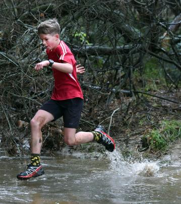 Jonty Scott, 11, of Lime Hills School, dashes through a waterway.