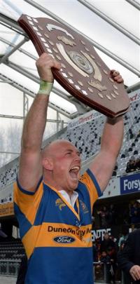 Taieri captain Charlie O'Connell hold the Speight's Championship Trophy aloft after his team beat...