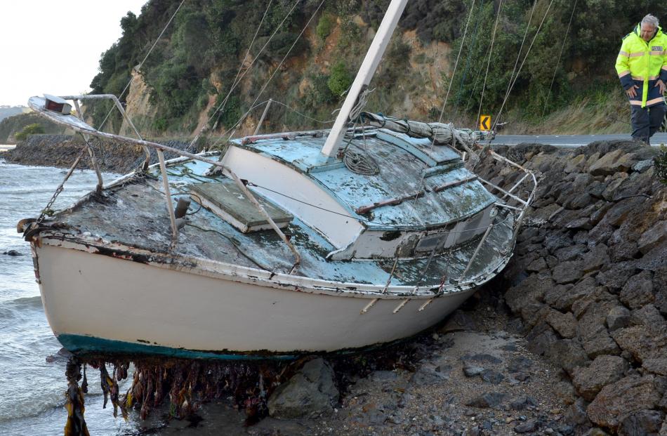 Senior Constable Lox Kellas takes a look at a yacht which broke its moorings and washed into the...