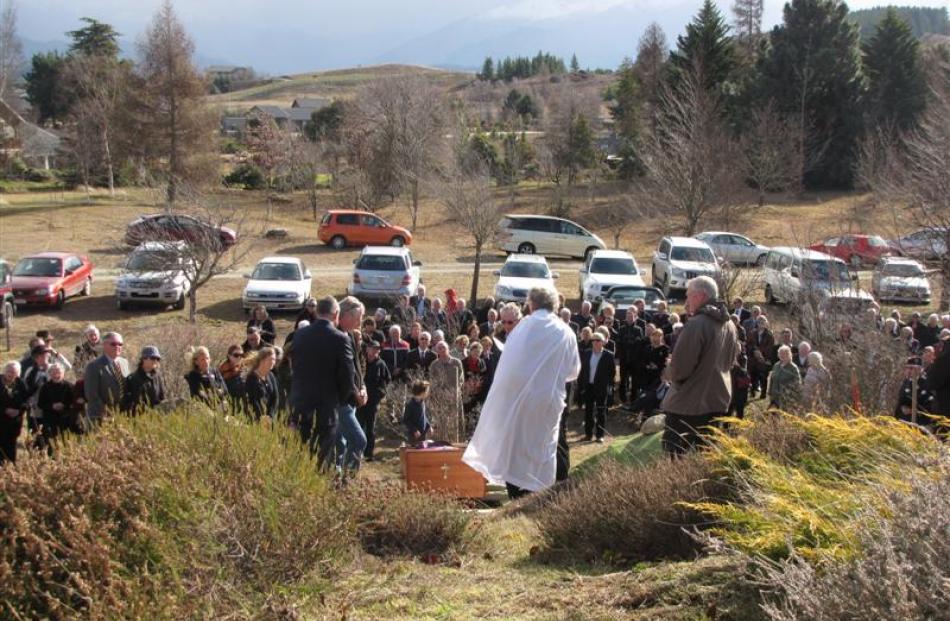 The Roman Catholic Bishop of Dunedin, the Most Rev Colin Campbell, officiates at the burial of...