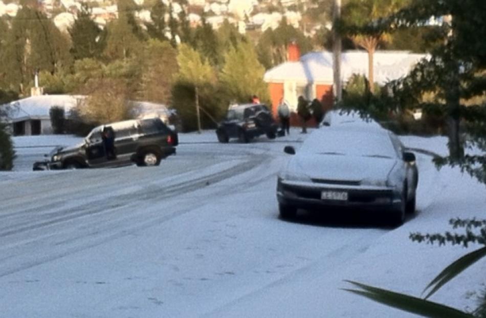 A car leaves a snow-covered Pine Hill Rd. Reader photo by Thim Yee