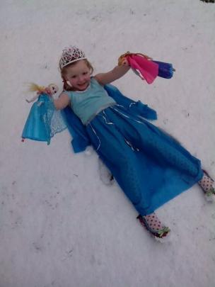 Queen Elsa (aka Annabelle Tocher) lies in the snow singing "Let it go, let it go" from her...