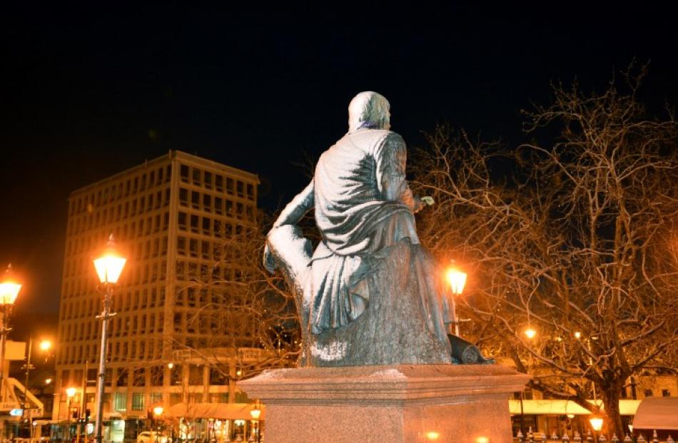 The statue of Robbie Burns wears a mantle of snow.