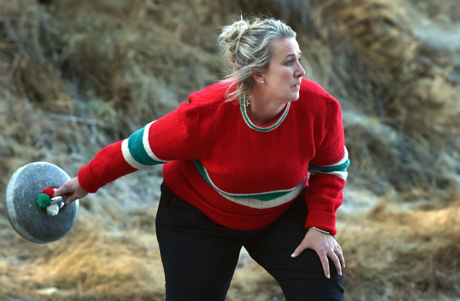 Stacey Weir, of Dunedin, swings her stone.