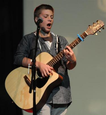 Kaleb Reid (13) displays his skills on guitar.
