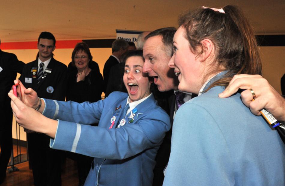 Prime Minister John Key poses for a selfie with Claudia Paterson (left) and Harriet Keown of St...