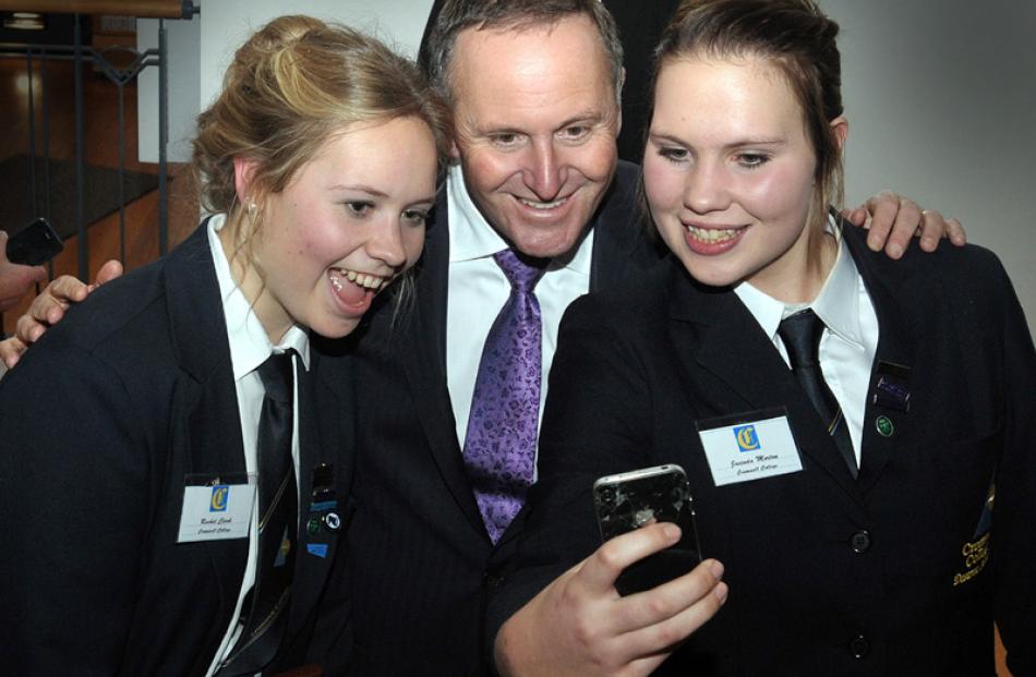 Rachel Clark and  Jacinda Morton take a selfie with Prime Minister John Key.