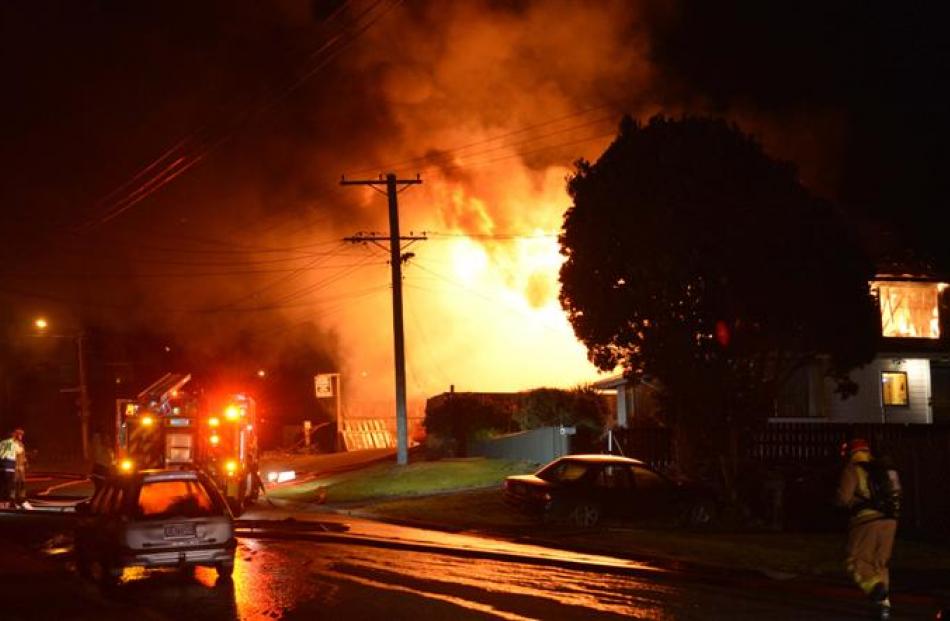 Flames pour from an Ocean Grove house destroyed in a fire last night.
