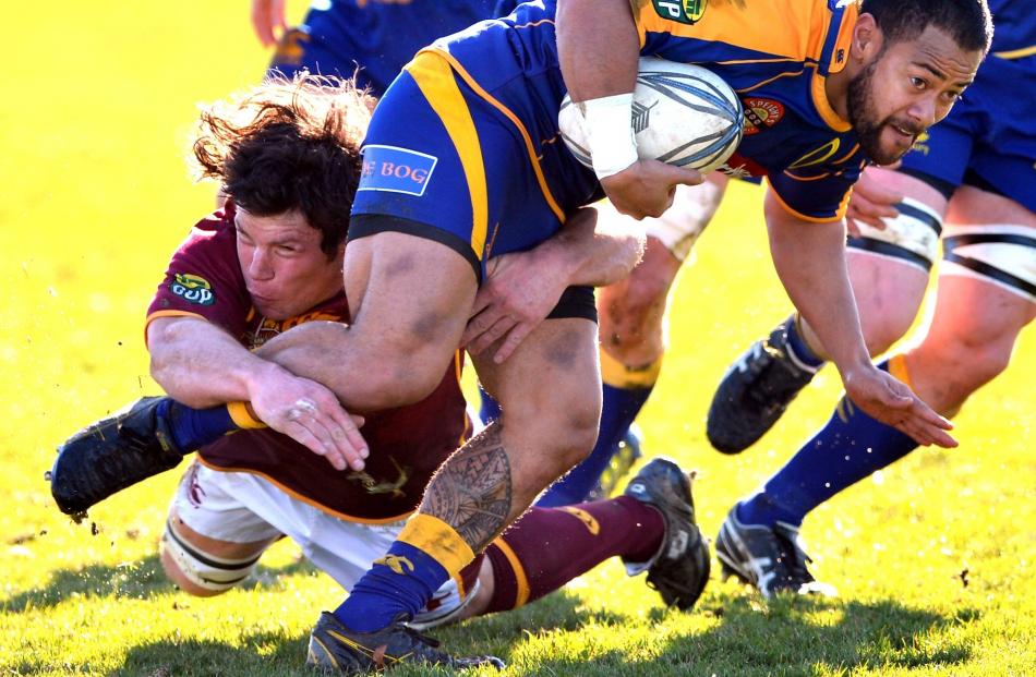 2012 - Buxton Popoali'i of Otago is tackled by Tim Boys of Southland during the Otago against...