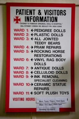 A sign shows the various 'wards' where dolls, rocking horses and prams can be admitted for repair.