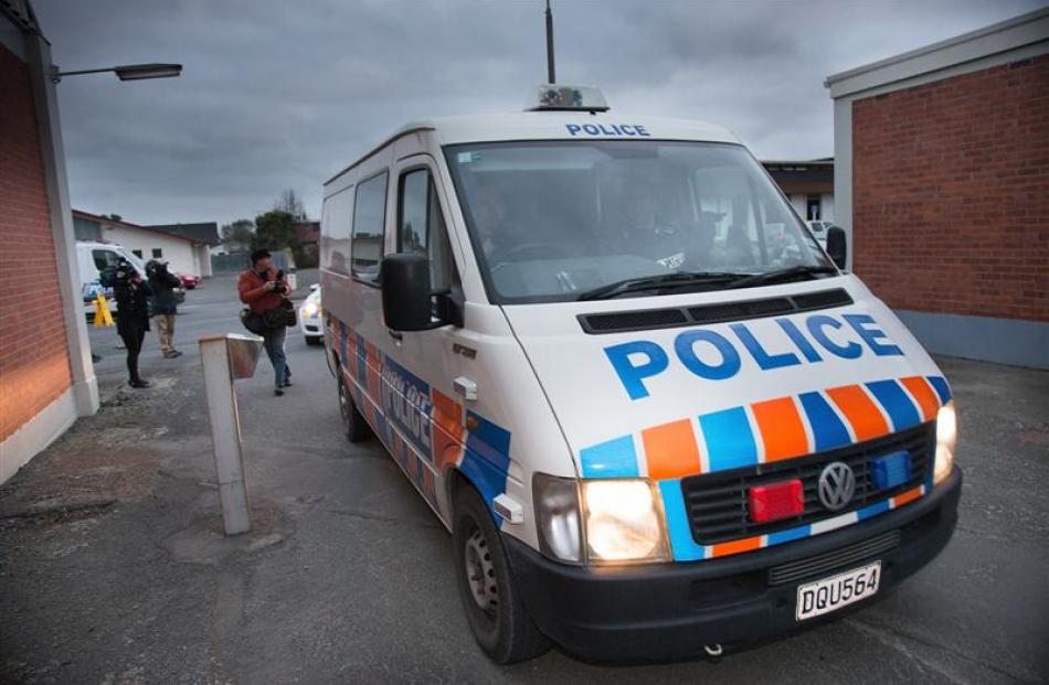 The arrested man arrives at the Ashburton Police Station. Photo by NZ Herald.