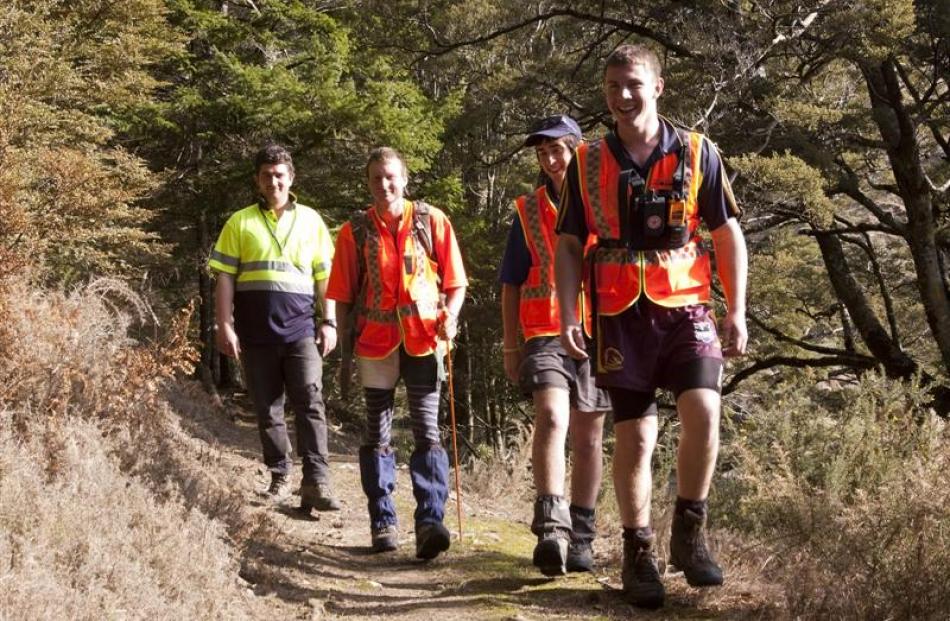 Seachers (from left) Riki Gutsell, Scott Henderson, David Woodrow and Cameron Way search the...