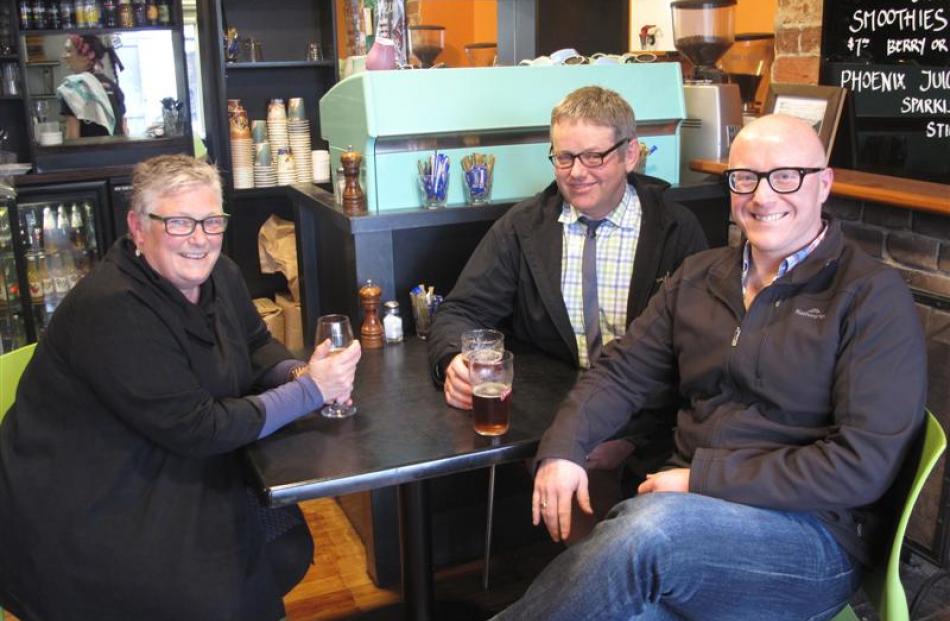 Friends Bridget Schaumann, Duncan McLean (centre) and Stewart Tagg enjoy a drink in St Clair.