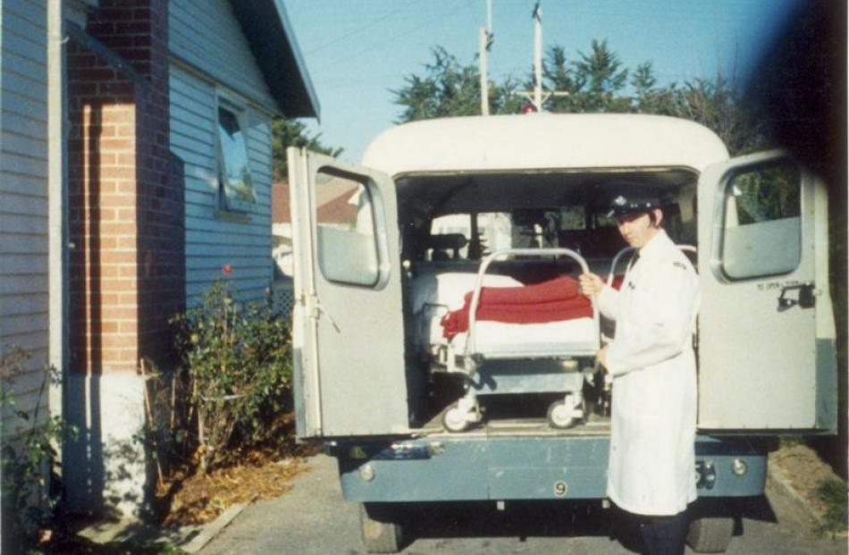 An ambulance officer unloads an ambulance in the early days of the service in Mosgiel.