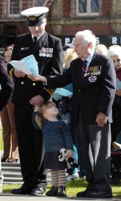 Lieutenant Commander Phil Bradshaw and daughter Isabelle share an order of service with Gordon...