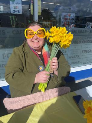Mataura Valley Milk staff member Anya Takau sells daffodils during the appeal. PHOTO: SANDY SMITH 