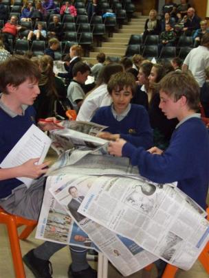 Competing in the newspaper ''scavenger hunt'' are Mount Aspiring College pupils (from left) Tom...