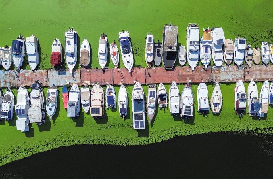 A drone image shows moored boats in the River Sava's inlet, where water has been covered with...