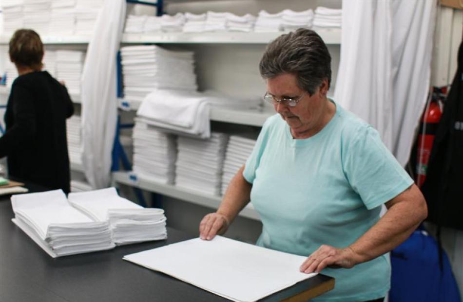 Penny Powell folds pillowcases for delivery.