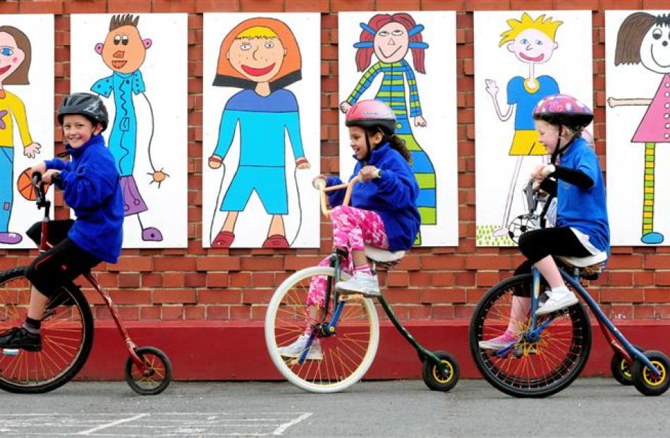 Milton Primary School pupils Jonathan Williams, Adorique May and Shayna Lloyd ride penny...