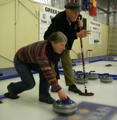 Sam Inder gives pointers to Shona Somerville on how to throw a curling stone at the Naseby...