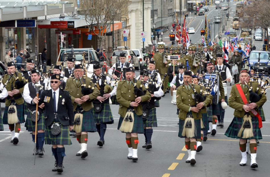 The City of Dunedin Pipe Band leads.