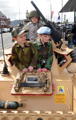 The Holgate children of Dunedin explore a 1957 scout car. Max (7) , Zachary (11) and Zoe (9).