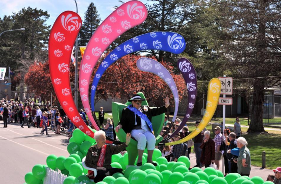 Riding the Contact Energy float, Senior Queen Pat Lines, 73 and runner-up Rita Perry, 93.