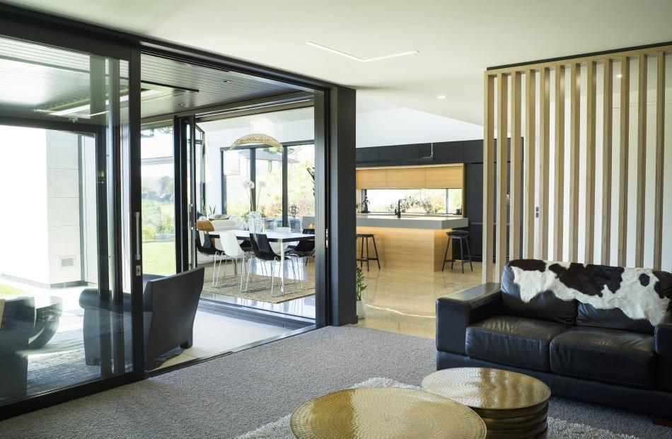 The media room is one of several spaces that opens to the outdoors.
