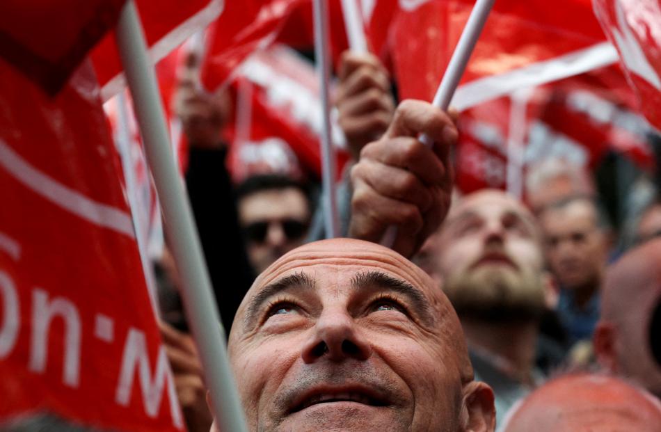 A man looks up as members of the two main Spanish trade unions demand fewer working hours of 37.5...