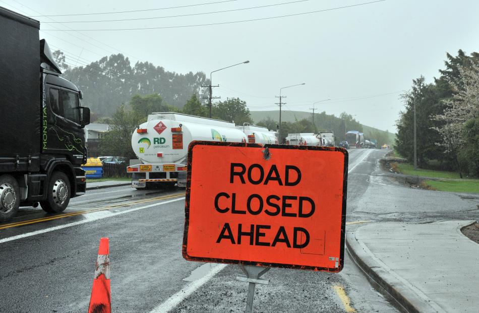 SH1 closed at both Waihola and Milton because of flooding across the road near the intersection...