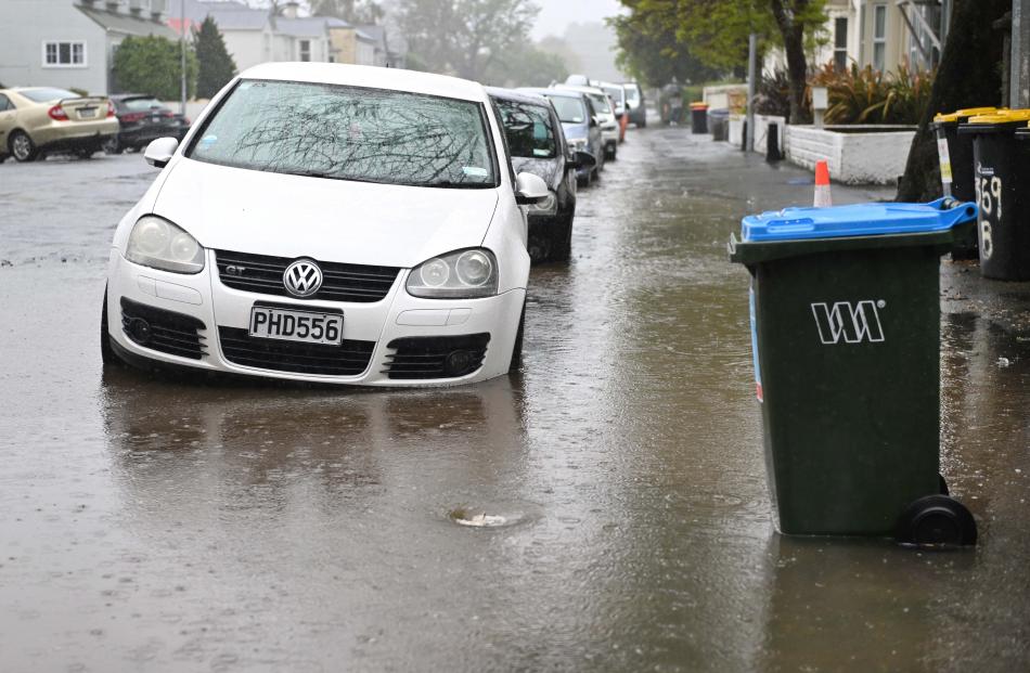 Blocked drains lead to deep puddles in Leith St, Dunedin, yesterday. PHOTO: GERARD O’BRIEN