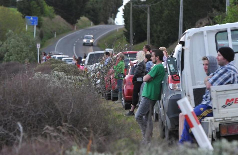 Onlookers parked their cars and watched from Brighton Rd as firefighters fight the flames.