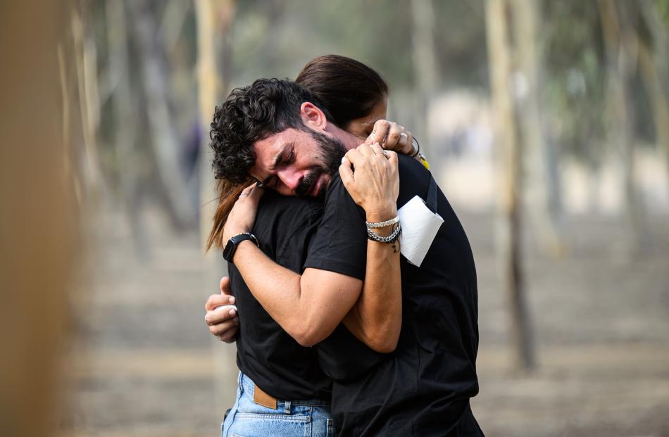 A man and a woman embrace as family members and friends of the lost and kidnapped gather at the...