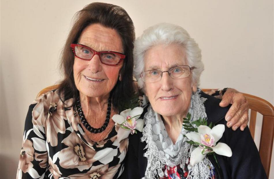 Twin sisters Edie Mercer (left) and Myrtle Macdonald (both nee Weddell) celebrate their 90th...